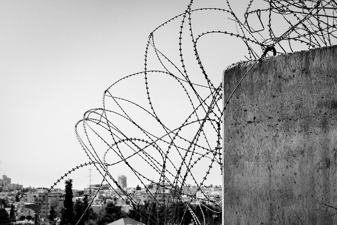 Barbed wire above a wall.